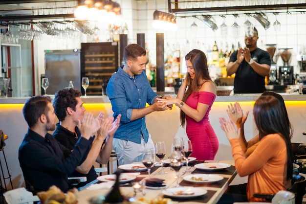 Proposal in a restaurant at dinner with friends