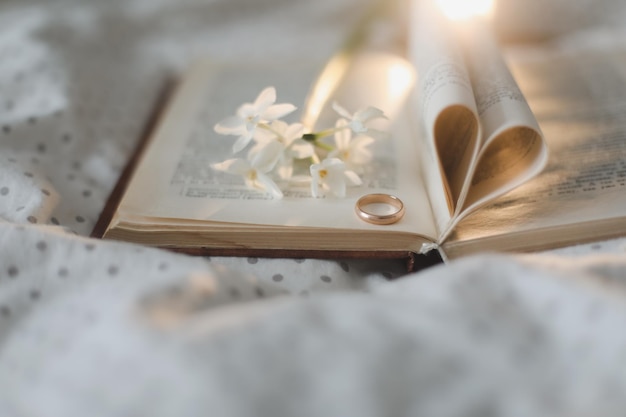 Proposal ring and a book with folded sheets in heart shape Wedding Love Valentines Day concept