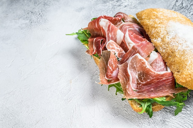 Prosciutto parma ham sandwich on ciabatta bread with arugula.