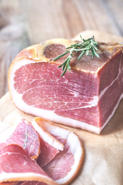 Prosciutto with fresh rosemary on the wooden board