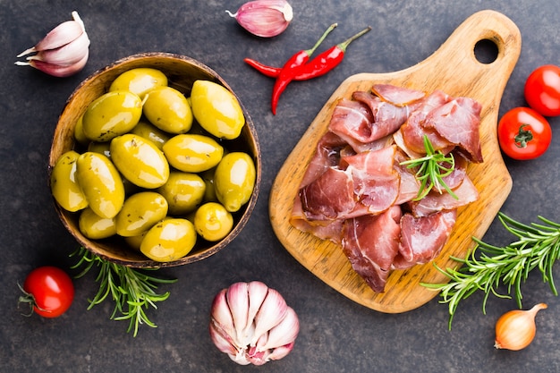 Prosciutto with rosemary on black