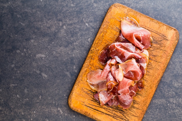 Prosciutto with rosemary on black