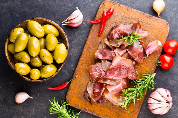 Prosciutto with rosemary on black