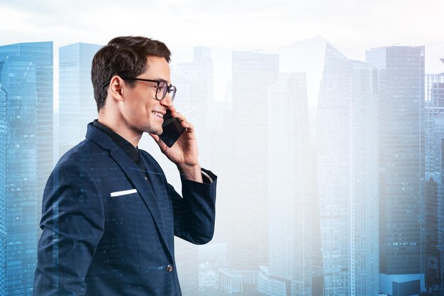 prosperous handsome entrepreneur in suit and glasses pensively talking phone and looking on singapore cityscape the concept of problem solving consulting downtown view double exposure