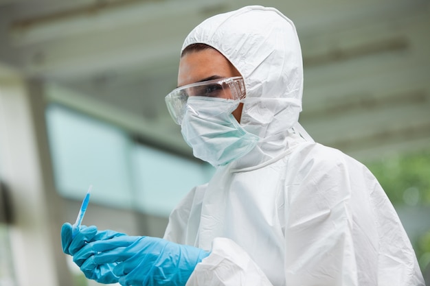 Protected science student posing with dangerous liquid