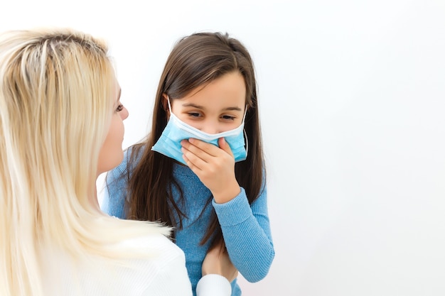 Protection against contagious disease, coronavirus concept. Mother and daughter wearing hygienic mask to prevent infection, respiratory illness such as flu, . minimize risk of Viral transmission.