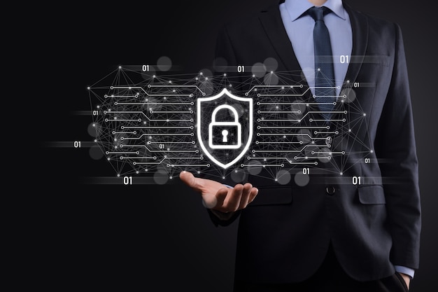 Protection network security computer and safe your data\
concept, businessman holding shield protect icon. lock symbol,\
concept about security, cybersecurity and protection against\
dangers