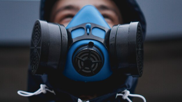 Protection respirator half mask for toxic gas.The man prepare to wear protection air pollution in the chemical industry