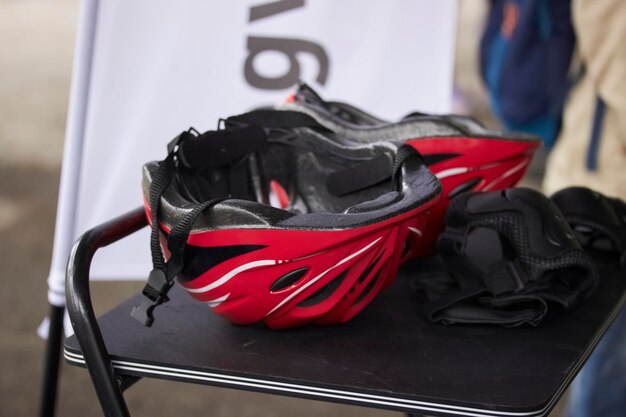 protective bicycle helmet in red color on a black table