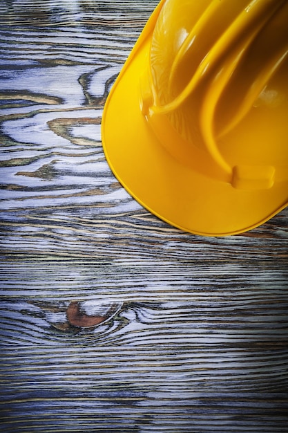 Protective building helmet on vintage wooden board