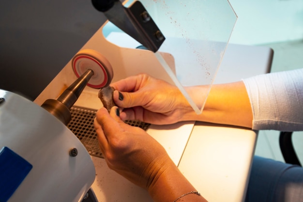 Protective glass when grinding amber. work with amber, a
precious stone in women's hands, the work of a jeweler