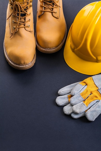 Protective glove helmet working boots on black background