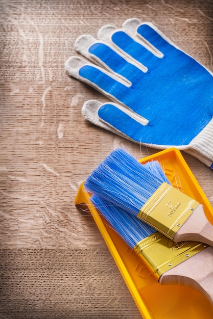 Protective gloves paint brushes tray construction concept