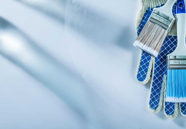 Protective gloves paintbrush on white background copyspace