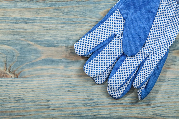 Protective gloves on wooden board construction concept