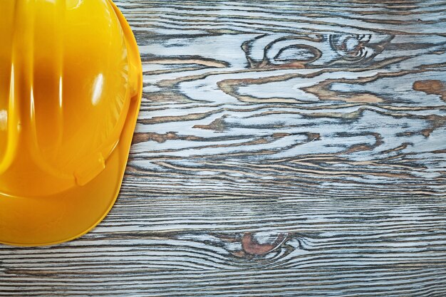 Protective hard hat on vintage wooden board