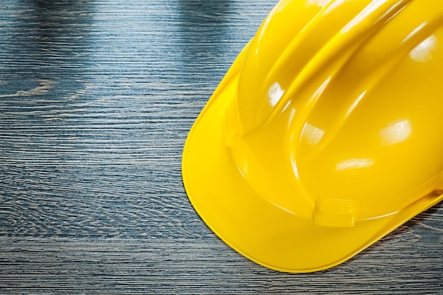 Photo protective hard hat on wooden board.