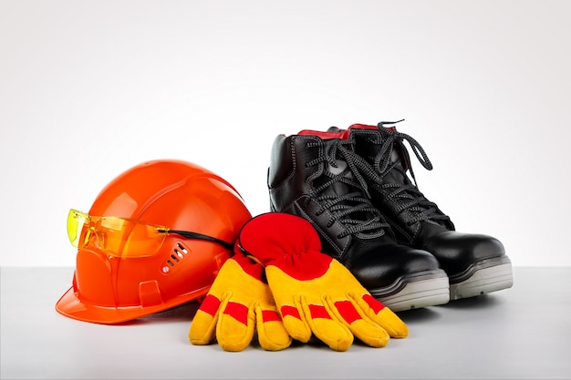 Protective helmet, boots, gloves and glasses. Standard construction safety.