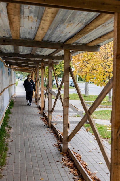 A protective shed at a construction site above the pedestrian road. Safe construction in the city center.