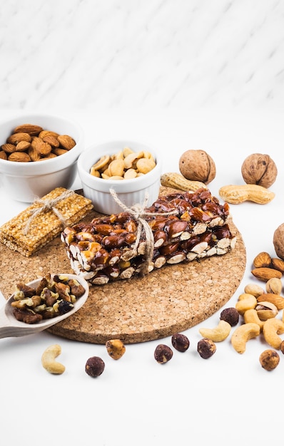 Protein bar with dried fruits on white backdrop