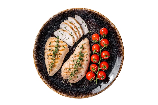 Protein dinner grilled Turkey breast fillet steaks on a plate with tomato Isolated on white background