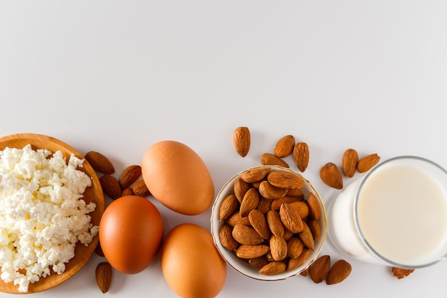 Protein food on a white background  cottage cheese eggs nuts