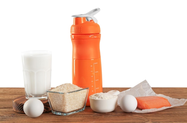 Protein shake in bottle scoop with powder and products on table