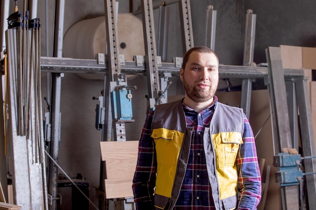 Proud carpenter at woodworking factory working place