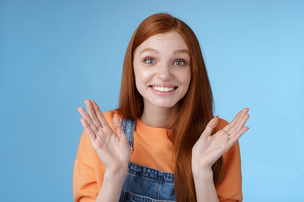 Proud happy supportive young redhead girl friend clapping hands gladly smiling congratulating girlfriend achieve success express happiness cheering attend awesome performance clasping happily