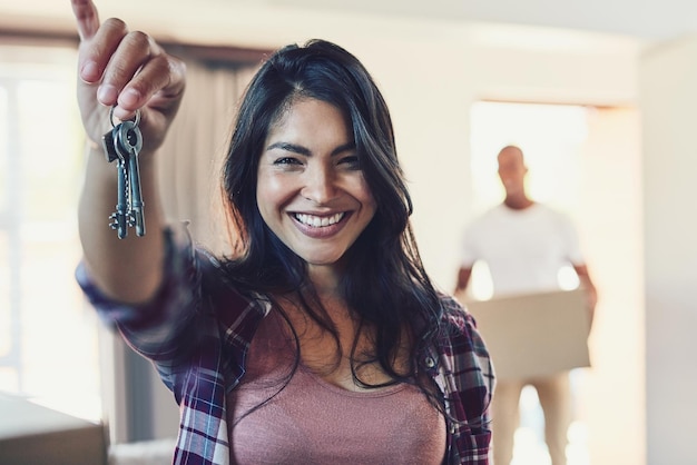 Photo proud of this amazing milestone portrait of a young woman holding the keys to her new home