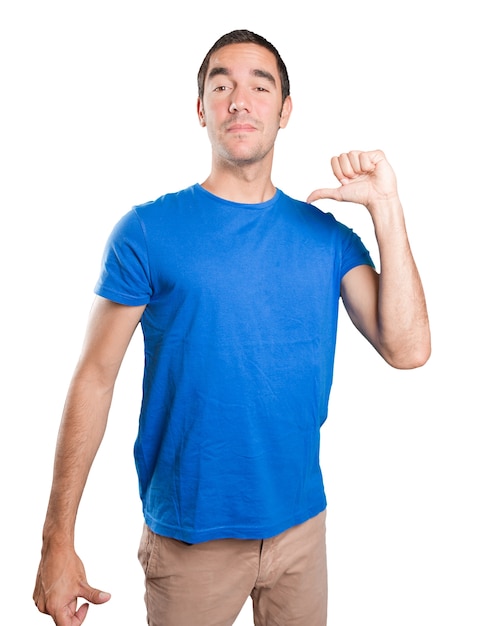 Proud young man against white background