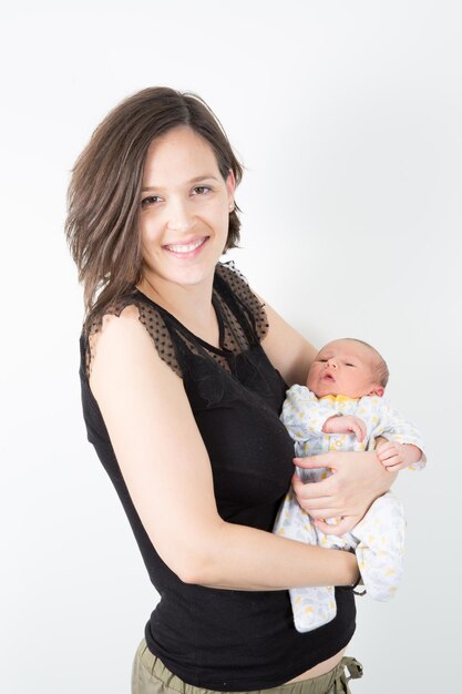 Pround young beauty mother with baby newborn in arms