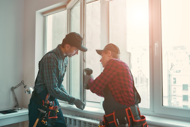 Provading best service men are installing a window