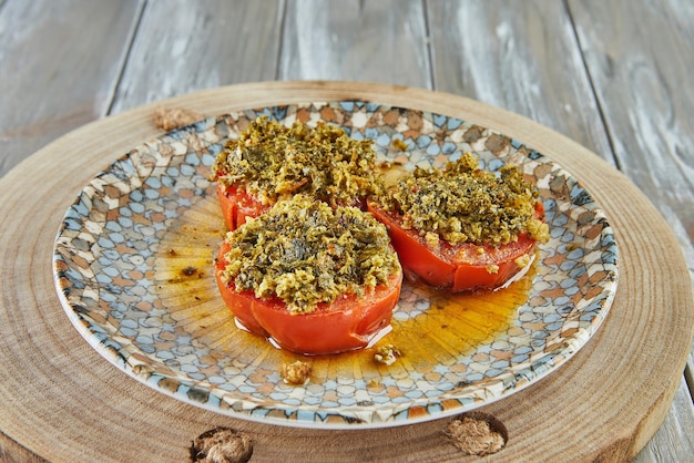 Provence tomatoes on plate on wooden background