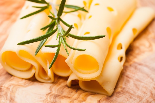 Provolone dolce cheese slices on a wooden board