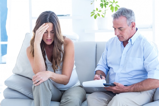 Psychiatrist advising depressed pregenat woman