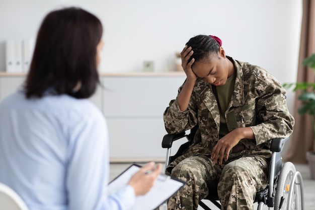 Psychological therapy for veterans psychologist lady having meeting with disabled soldier woman