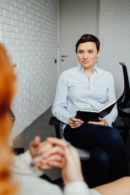 A psychologist meets with a client in the office help with stress