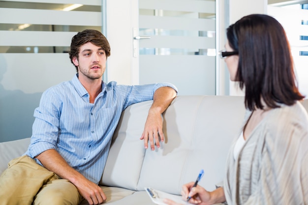 Psychologist talking with depressed man