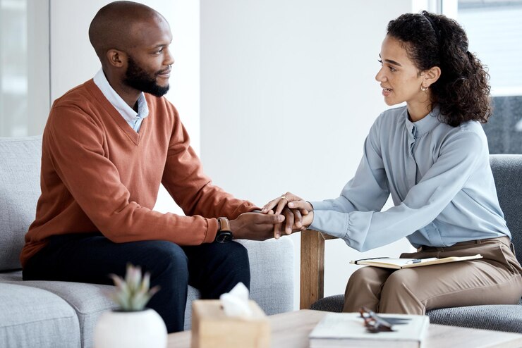 Photo psychology support and black woman psychologist or therapist holding hands client empathy and depression mental health counseling and therapy patient talking of problem health expert listening