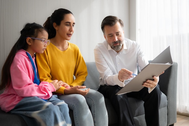 Psychotherapist working with child patient and mother in office Concept of psychotherapy