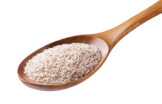 Photo psyllium in a wooden spoon closeup on a white background isolated