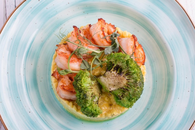 Ptitim with curry sauce shrimp and broccoli Serving a restaurant menu dish