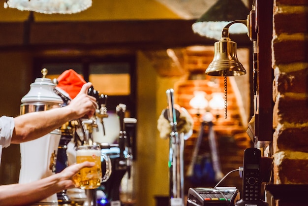 Pub interior. evening time in bar. waiter at work