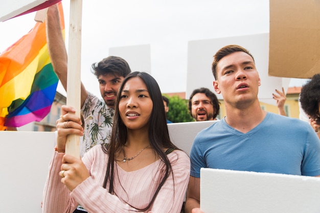 Public demonstration on the street against social problems and human rights. Group of multiethnic people making public protest