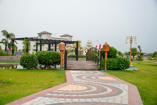 a public park in kharian city pakistan with a wooden bridge and pathway