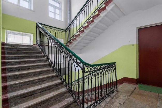 Public staircase in the old house of the city of St Petersburg on a sunny day