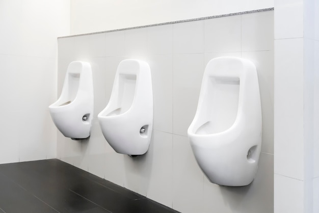 public toilet clean modern white tiles urinal.