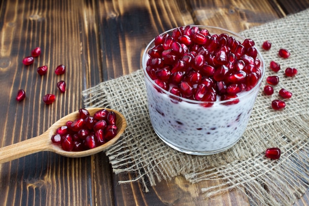 Pudding with chia and garnet on the rustic wooden