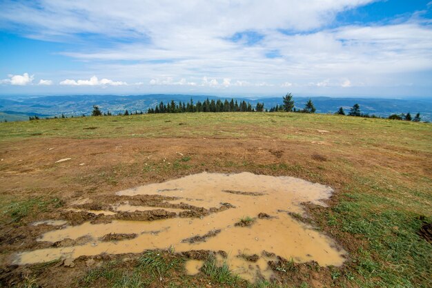 Puddle of mud on the hill top after rainy day